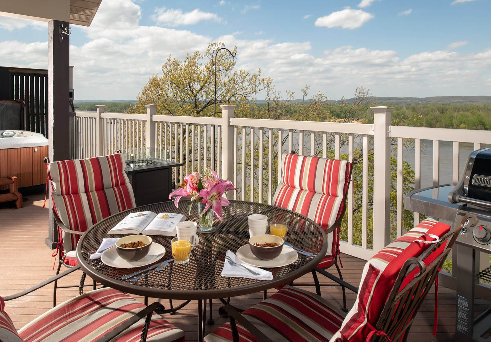 Deck with hot tub, gas grill, and fire pit table.