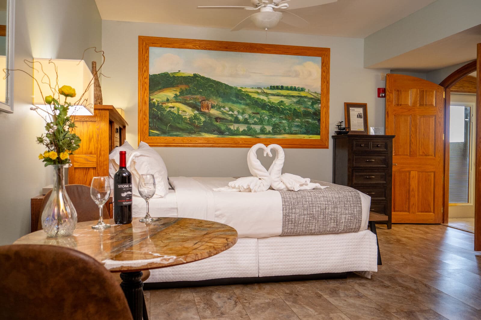 Chambourcin's King size Bedroom with white linens and swans made out of towels