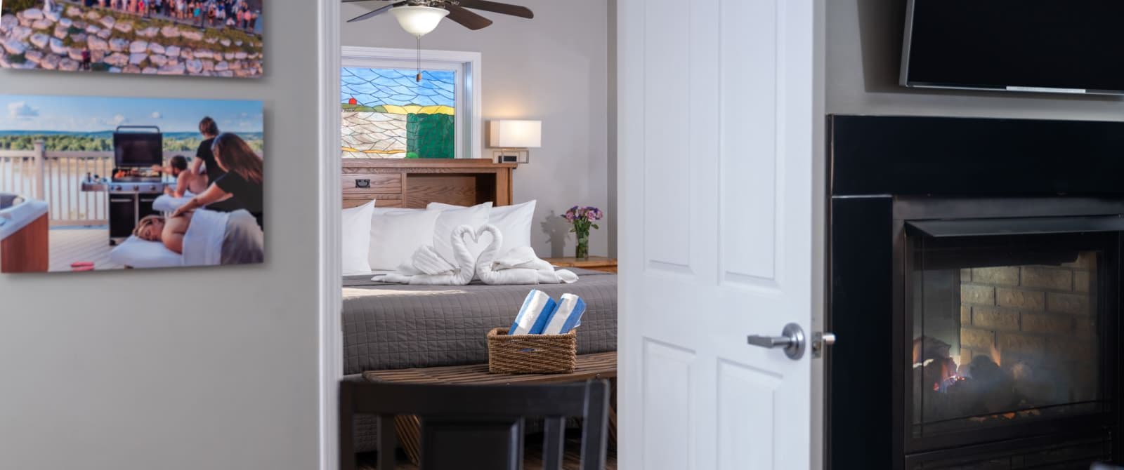 view of bed through door in living room with fireplace