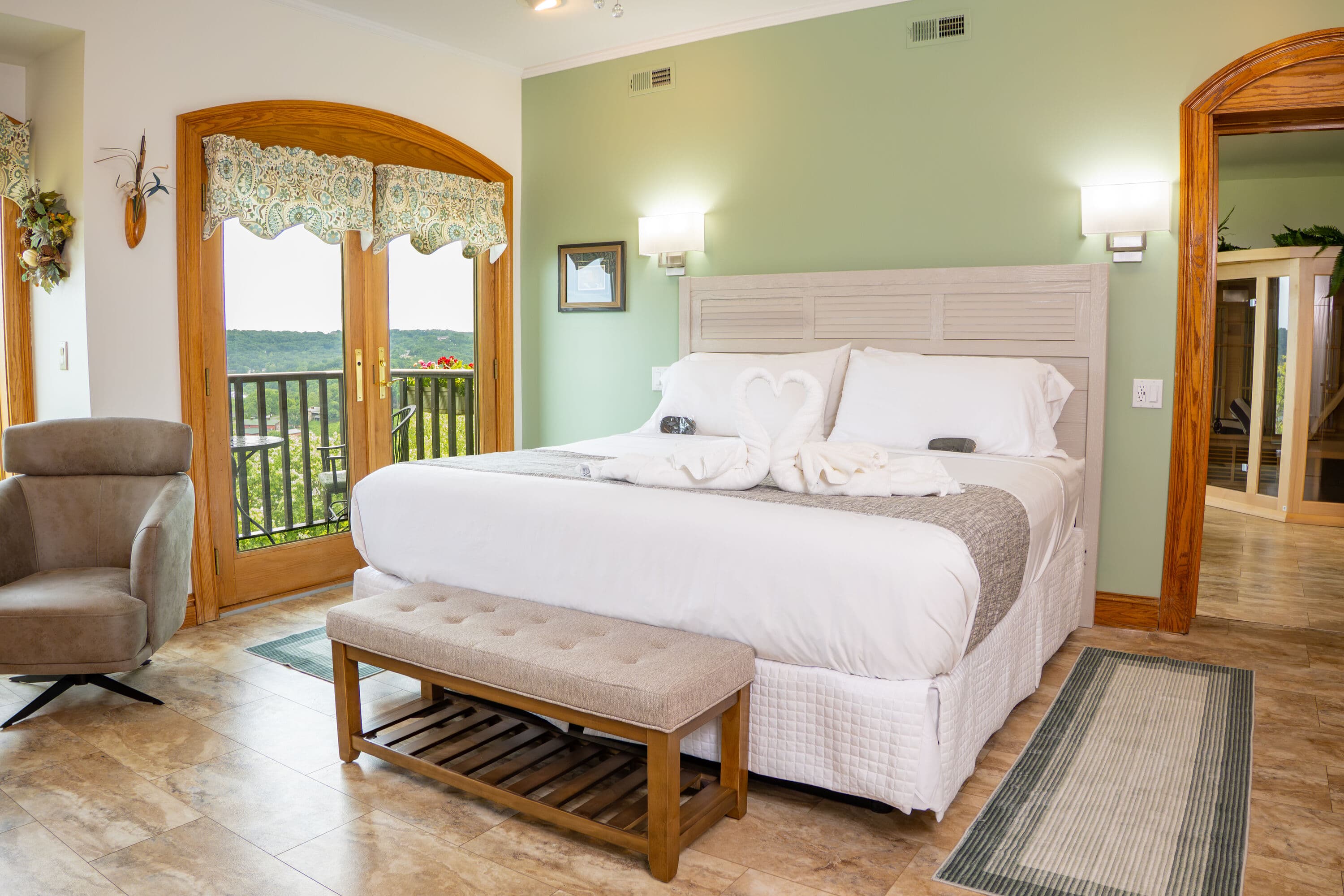 King size bed with white linens with french door with view outside to a porch