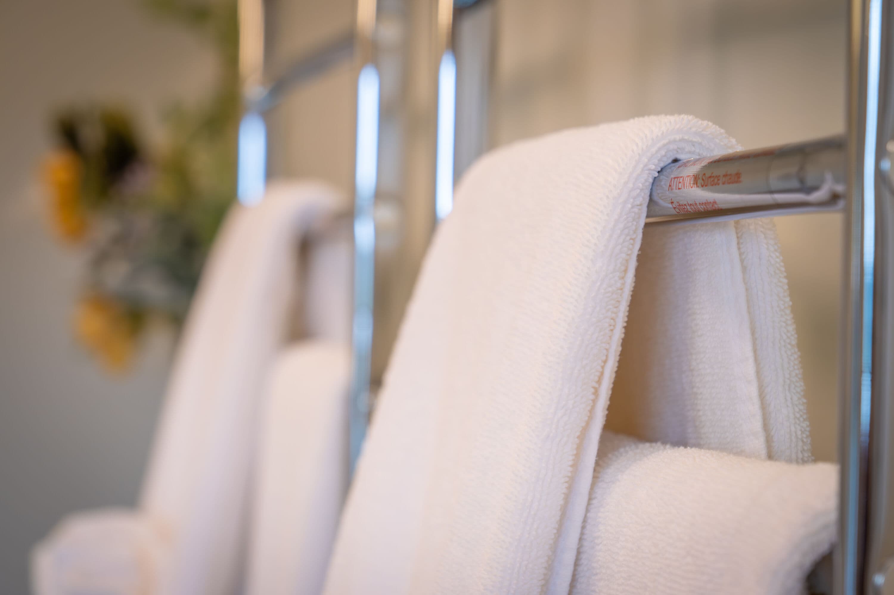 white towels close up photo hung on towel rack