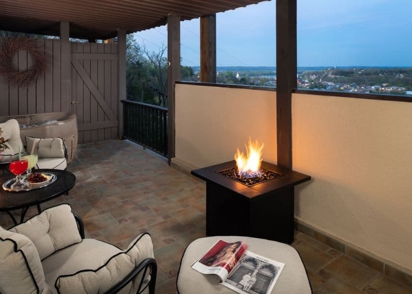 Cozy balcony with a fire pit, comfortable seating, and a scenic view. Cozy balcony with a fire pit, comfortable seating, and a scenic view.