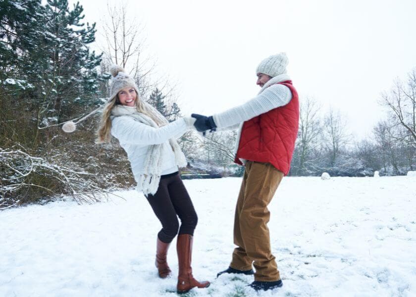 a romantic couple dancing while on a winter hike a romantic couple dancing while on a winter hike