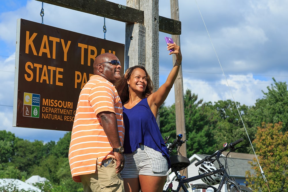 Couple at the Katy Trail State Park sign