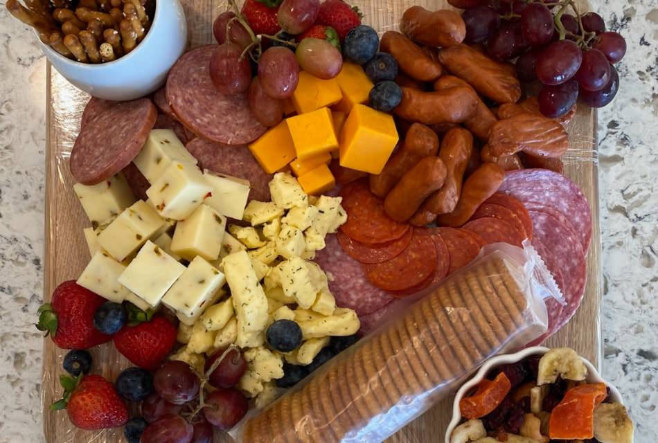 Close up view of charcuterie board with meats, cheeses, fruits, and crackers