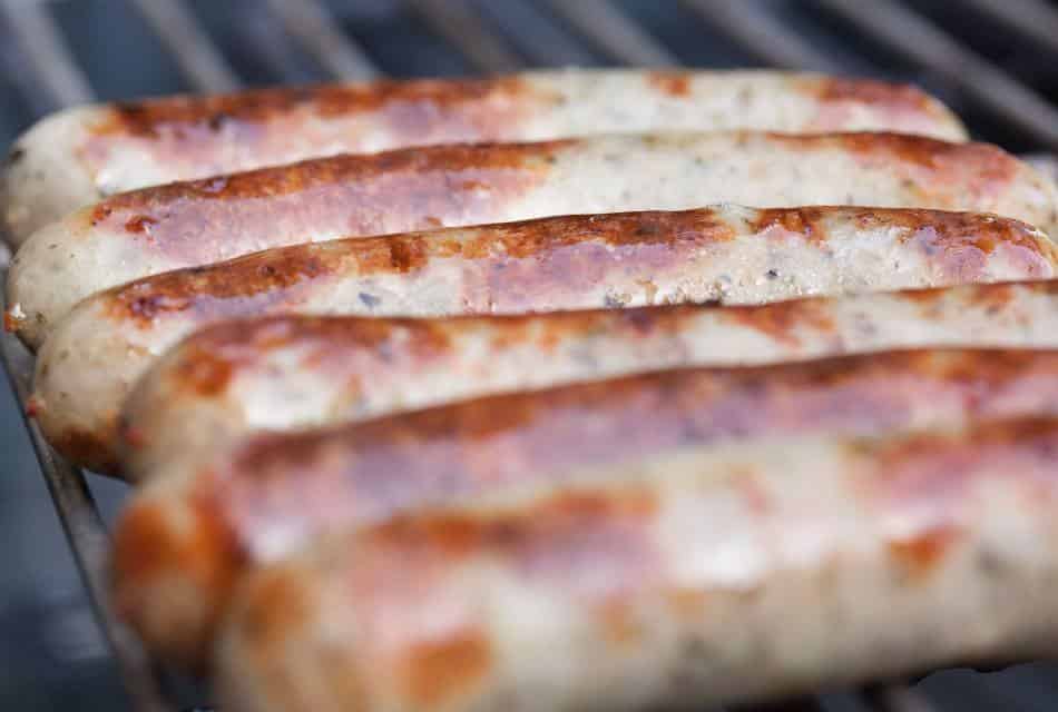 Close up view of brats on the grill
