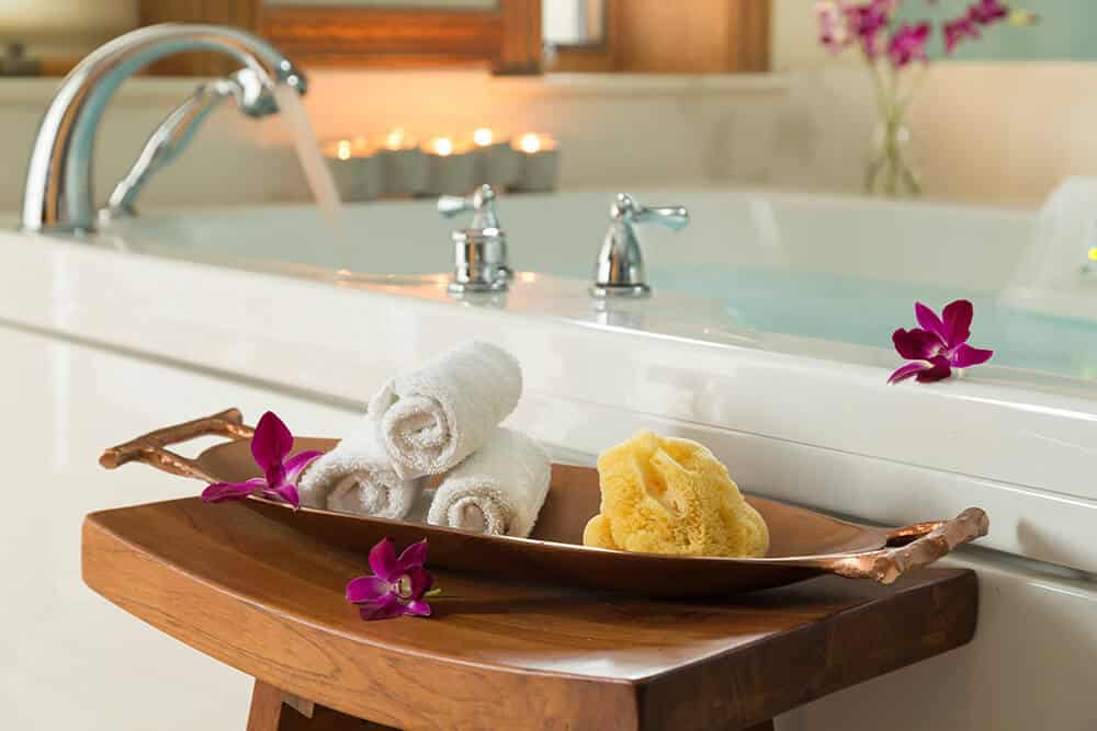 Jetted tub surrounded by candles and flower petals