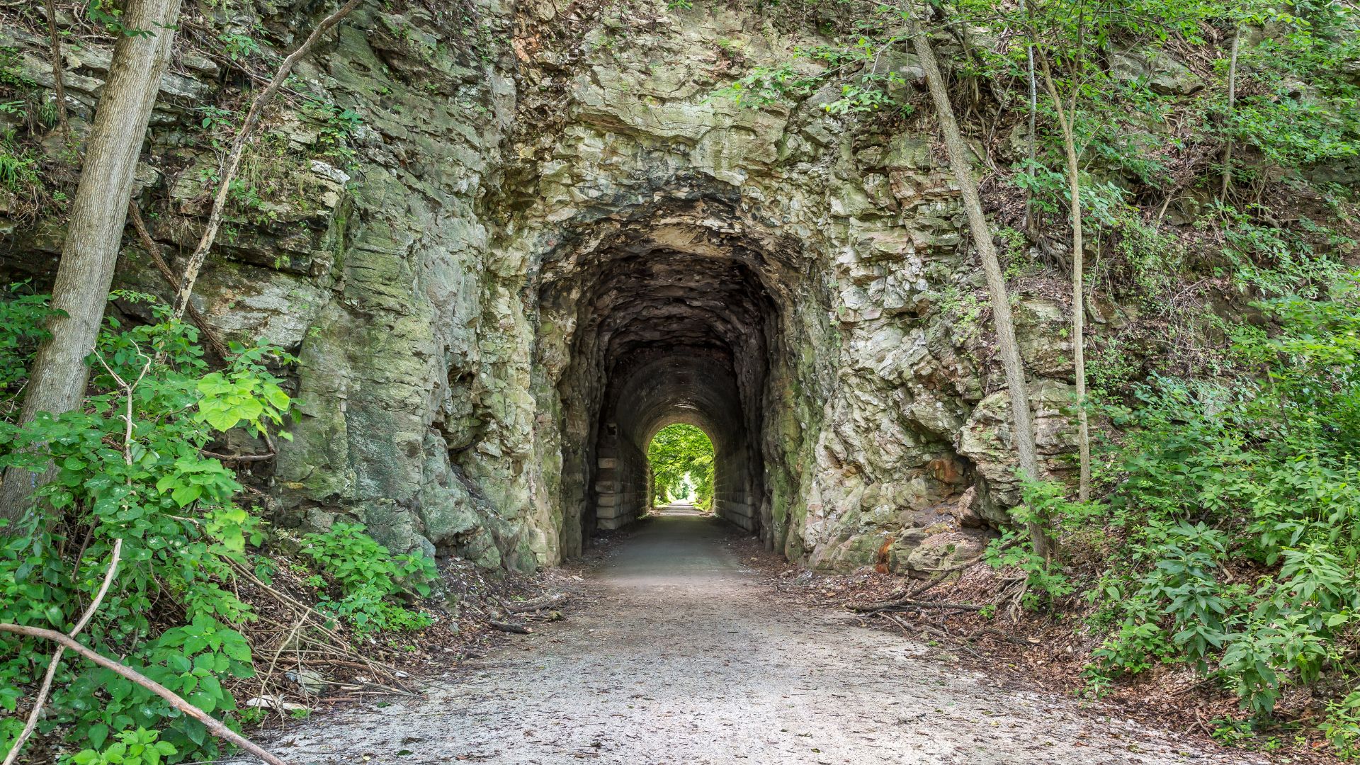 Arched entry through a rocky hillside into the Katy Trail in Missouri.