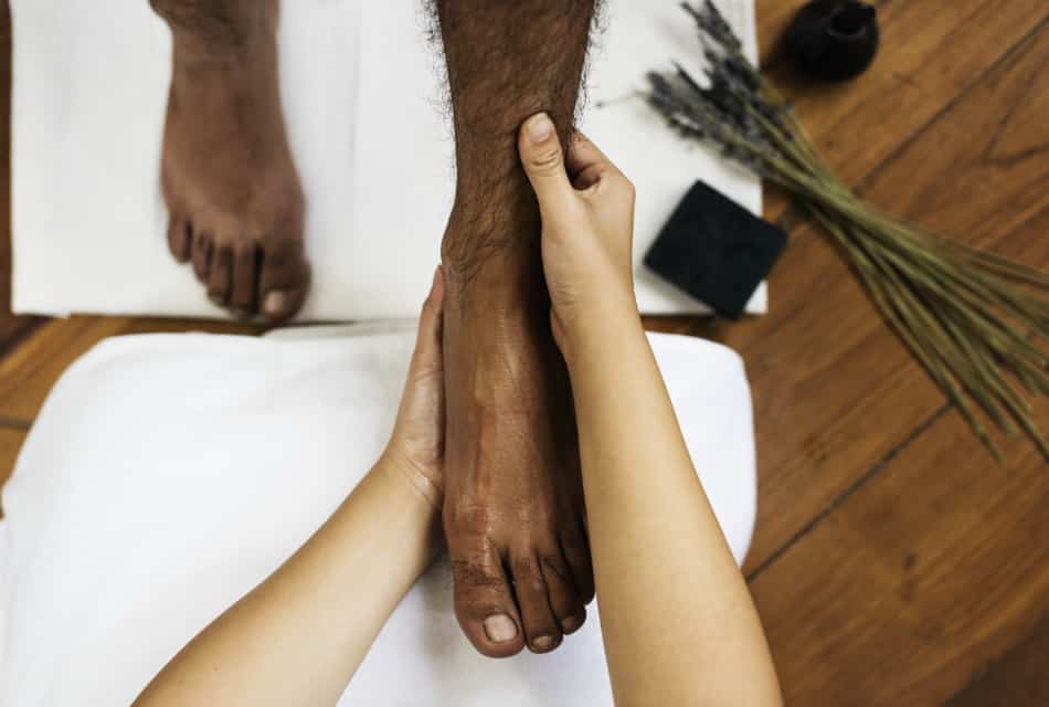 Woman massaging a man's foot